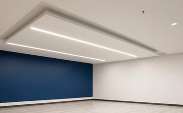 A wide photography shot of a modern North American office interior showcasing a flawlessly installed suspended ceiling and premium painted walls. The lighting is clean and bright, demonstrating a professional and high-quality finish with Off-white and Dark Blue tones.