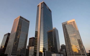 Wide-angle photograph of a modern, imposing financial district in South America during twilight. The cold steel and glass buildings are illuminated with gold lighting, reflecting a scene of absolute corporate power, technology, and strategic discipline.