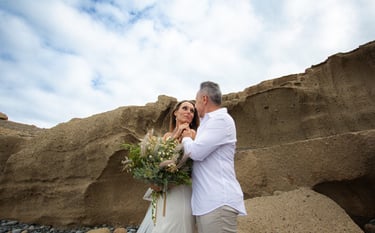Romantic moment captured between newlyweds on a Tenerife coastline.
