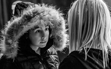 Two young ladies facing each other deep is discussion about a dance performance issue