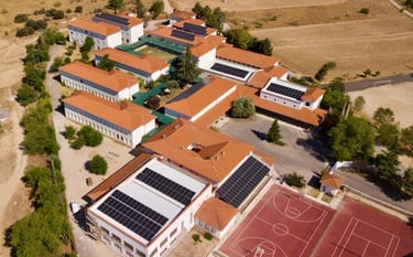 a school with solar panels on the roof