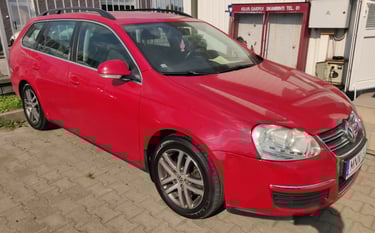a red car parked in front of a building