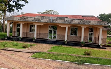 a house with a red roof and a brick building