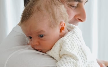 a man holding a baby in his arms