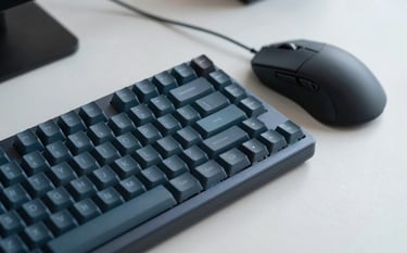 Macro photography of a mechanical keyboard and a high-end mouse on a clean desk in a modern Middle Eastern / Gulf environment. The lighting accentuates Muted Teal Blue and Dark Navy Blue tones. Minimalist aesthetic.