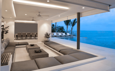 Luxury modern with sunken seating, outdoor lounge furniture, and infinity pool overlooking the ocean.