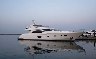 A wide-angle shot of a luxurious yacht docked in a serene harbor at dusk. The water is calm, reflecting the sea foam white hull and the steel mist sky. The mood is refined and trustworthy.