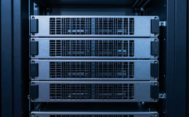 A close-up photograph of enterprise-grade server hardware in a pristine, minimalist data center. The lighting is cool and professional, featuring soft blue and deep navy blue reflections on metallic surfaces. The composition is clean and symmetric, emphasizing high-end technical reliability and Scandinavian design principles.