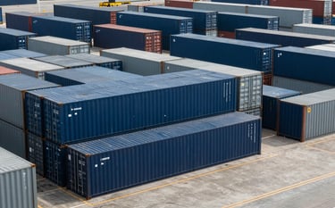A wide shot of a modern logistics terminal in Brazil with Navy Blue and Dark Gray containers, organized and efficient, symbolizing specialized legal compliance and order.