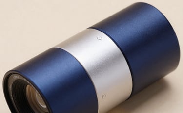 A close-up of a high-end, sleek metallic device in a clean professional studio. The lighting is crisp and intelligent, using tones of deep blue and off white to emphasize the sophisticated engineering and digital capability of the design.