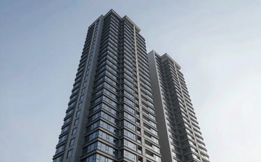 A dramatic low-angle shot of a luxury residential high-rise against a clear sky in a North American / US metropolitan area, clean mist grey and deep midnight navy tones, high-end photography.