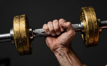 Macro close-up of a muscular hand gripping a heavy knurled barbell. The lighting is focused and dramatic, highlighting the texture of the metal in brass gold against a deep charcoal black background.