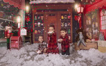 two children playing in a snow storm in a christmas card