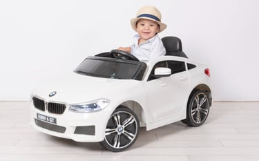 a little boy in a white shirt and hat