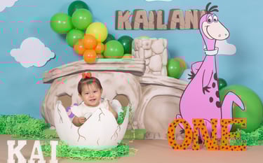 a baby in a dinosaur costume sitting in a dinosaur costume