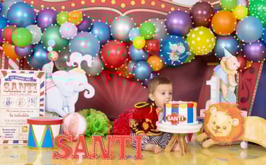 a baby boy in a circus themed birthday party
