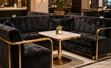 Luxury private members lounge in New Delhi featuring dark velvet seating, polished gold metal details, and warm, cinematic lighting, emphasizing a sophisticated and exclusive lifestyle.