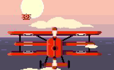 a red biplane flying over the ocean
