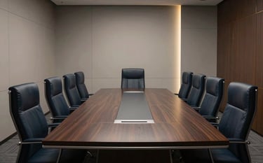 A sophisticated and empty executive boardroom in a North American office. A long dark wood table, leather chairs, and minimalist walls. Subtle gold accent lighting, deep navy shadows, and professional discipline.