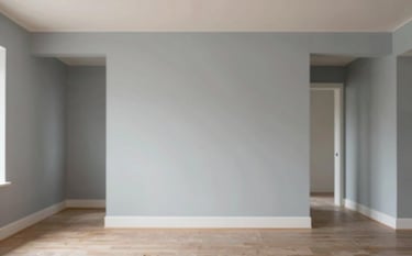 Interior shot of a renovated residential living space showing perfectly finished, smooth walls ready for paint. The lighting is warm yet professional. The aesthetic is clean and sturdy, reflecting high-quality residential work. Colors like #F8F9FA and #617488 appear in the architectural details.