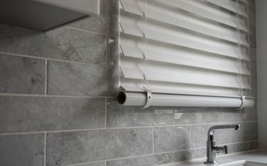 Detailed photography of high-quality interior finishes: elegant grey tiling on a splashback and precision-fitted modern blinds in an Auckland home. Soft lighting highlighting textures.