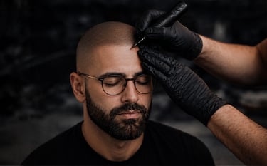 Professional scalp micropigmentation procedure creating a realistic hairline for a man with hair loss.