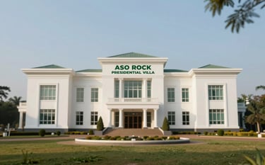 A professional architectural photograph of the Aso Rock Presidential Villa in Abuja, Nigeria. The image captures the white, modern building's grandeur against a clear blue sky. Soft morning light highlights the facade. The atmosphere is authoritative and serene. The brand's green tones (#2F6F4C) are subtly present in the manicured trees and landscape in the foreground.