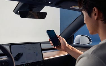 Photography of a person reviewing a high-tech car interior while holding a mobile phone, set in a bright and modern studio in Sydney, professional studio lighting with navy blue and muted blue accents in the background.