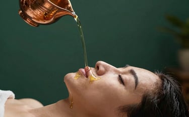 A close-up photograph of a Shirodhara treatment. A thin, continuous stream of warm oil flows from a traditional copper vessel onto the forehead of a person resting peacefully. The background is a sophisticated dark forest green wall. The atmosphere is quiet and meditative. Soft lighting highlights the texture of the oil.