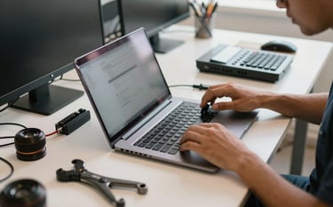 A clean and professional South American Brazilian computer repair station with specialized tools and a disassembled laptop on a light-colored desk, soft morning light, focused on efficiency and technical precision.