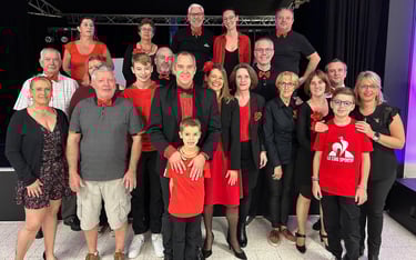 a group of people standing in front of a stage