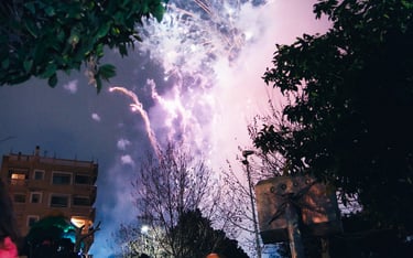 a group of people watching fireworks in the sky