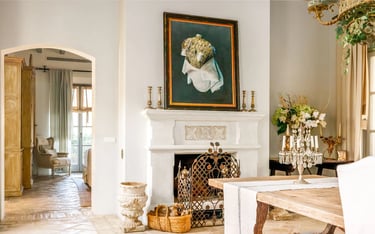 Fireplace with artwork and rustic decor at Finca Santa Katerina