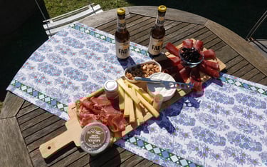 An appetizer board featuring cold cuts, cheeses, and local specialties to share