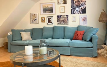 Salon cosy avec canapé et déco murale, hébergement professionnel