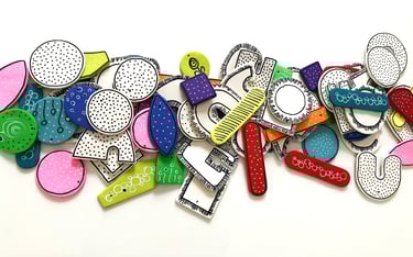 a bunch of different colored earring components