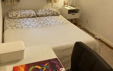 a bed room with a bed and a desk