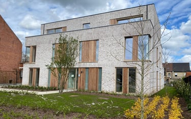 a house with a brick wall and a sign that says,