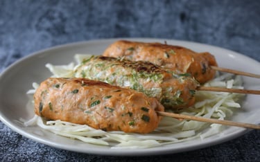 Japanese-style oven-roasted salmon and scallion skewers on a wooden stick