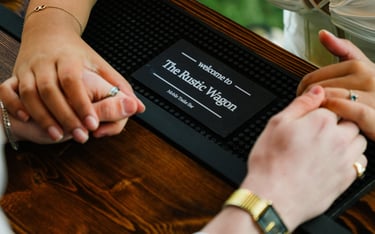 Couples holding hands in the background of The Rustic Wagon