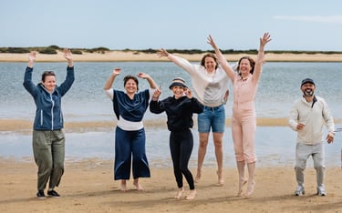 a group of people standing on a beach