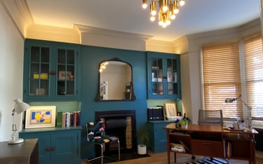 Home office layered lighting. Glow above and below cabinets lights up the space softly