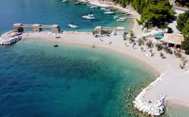 The photo shows the entirety of Rape Beach, one of the best family beaches around.