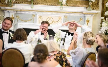 same-sex couple enjoying speeches after their wedding at The Trafalgar Tavern Greenwich