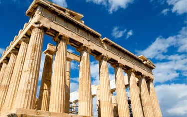 The ancient Parthenon temple on the Athenian Acropolis in Greece under a bright blue sky.