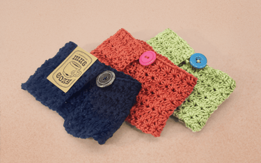 a set of three crochet mug cozies