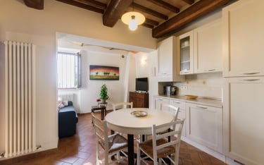 a kitchen with a table and chairs in the middle of the room