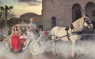 a man and quinceanera in a carriage drawn carriage