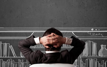 A manl sits back, visualising a large screen system, with a chalk-drawn screen