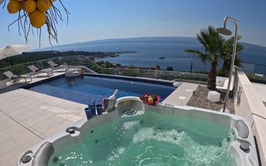 Villa Fay hot tub on pool deck with a view of the ocean